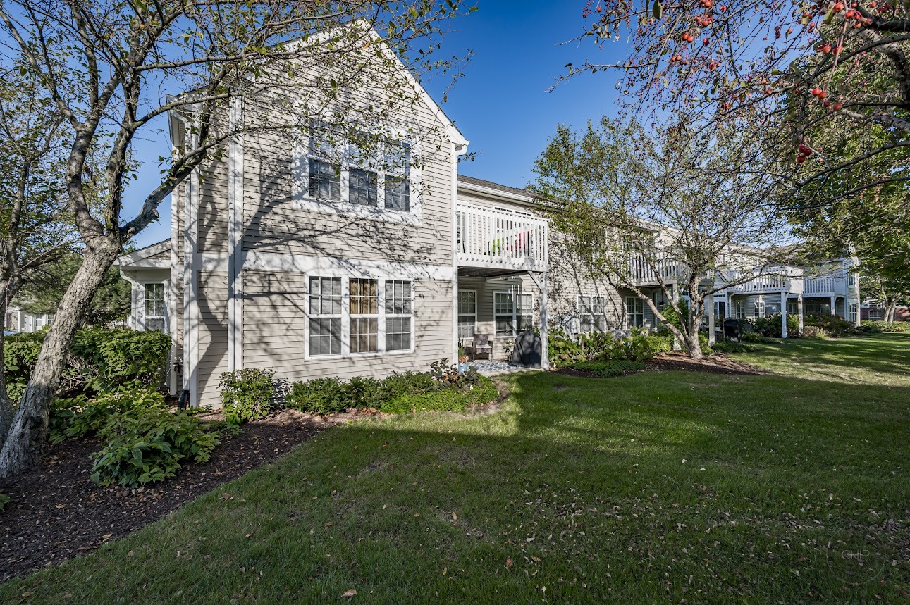 2827 Rutland Circle, Unit 101 Naperville, IL 60564 - Photo 23 of 25 a view of a house with a garden