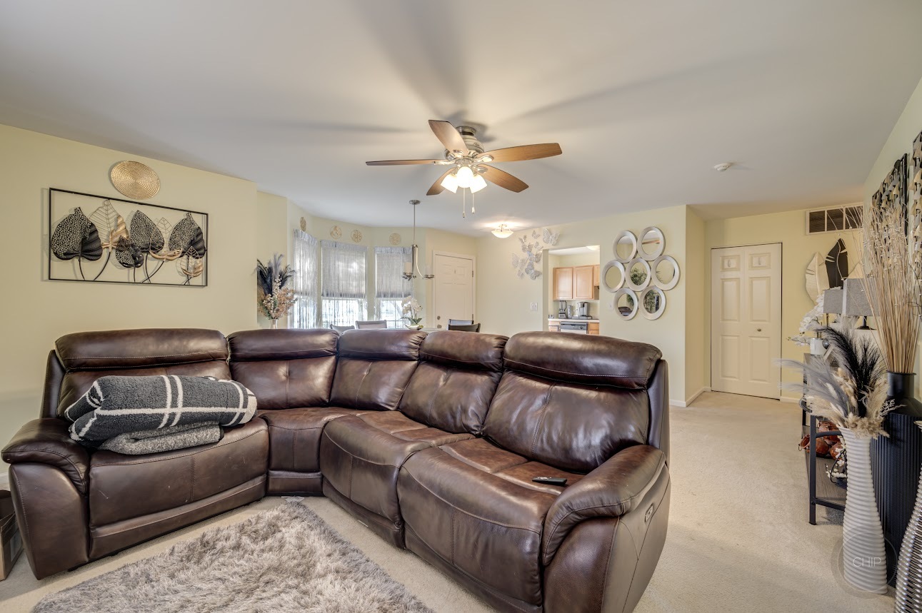2827 Rutland Circle, Unit 101 Naperville, IL 60564 - Photo 5 of 25 a living room with furniture and a chandelier