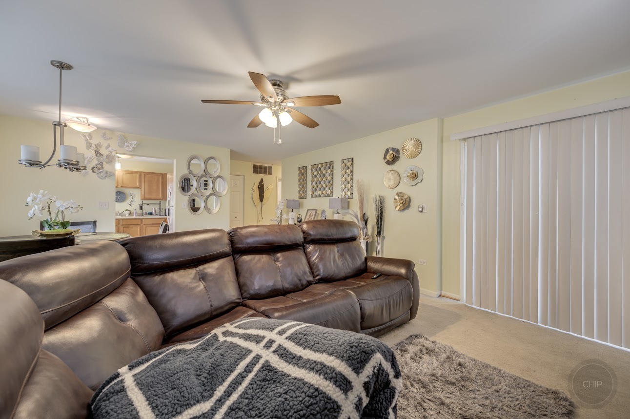 2827 Rutland Circle, Unit 101 Naperville, IL 60564 - Photo 6 of 25 a living room with furniture ceiling fan and a window