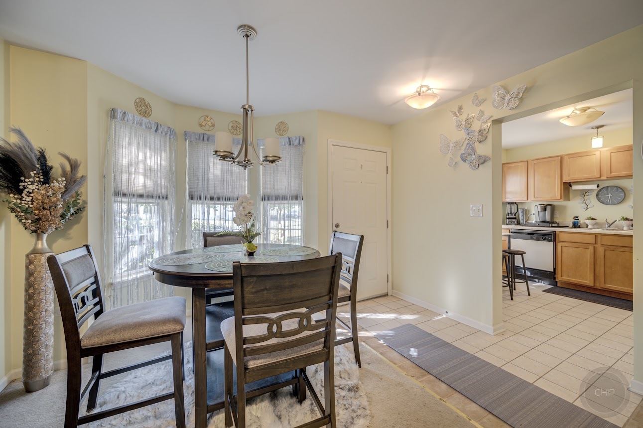 2827 Rutland Circle, Unit 101 Naperville, IL 60564 - Photo 8 of 25 a view of a dining room with furniture