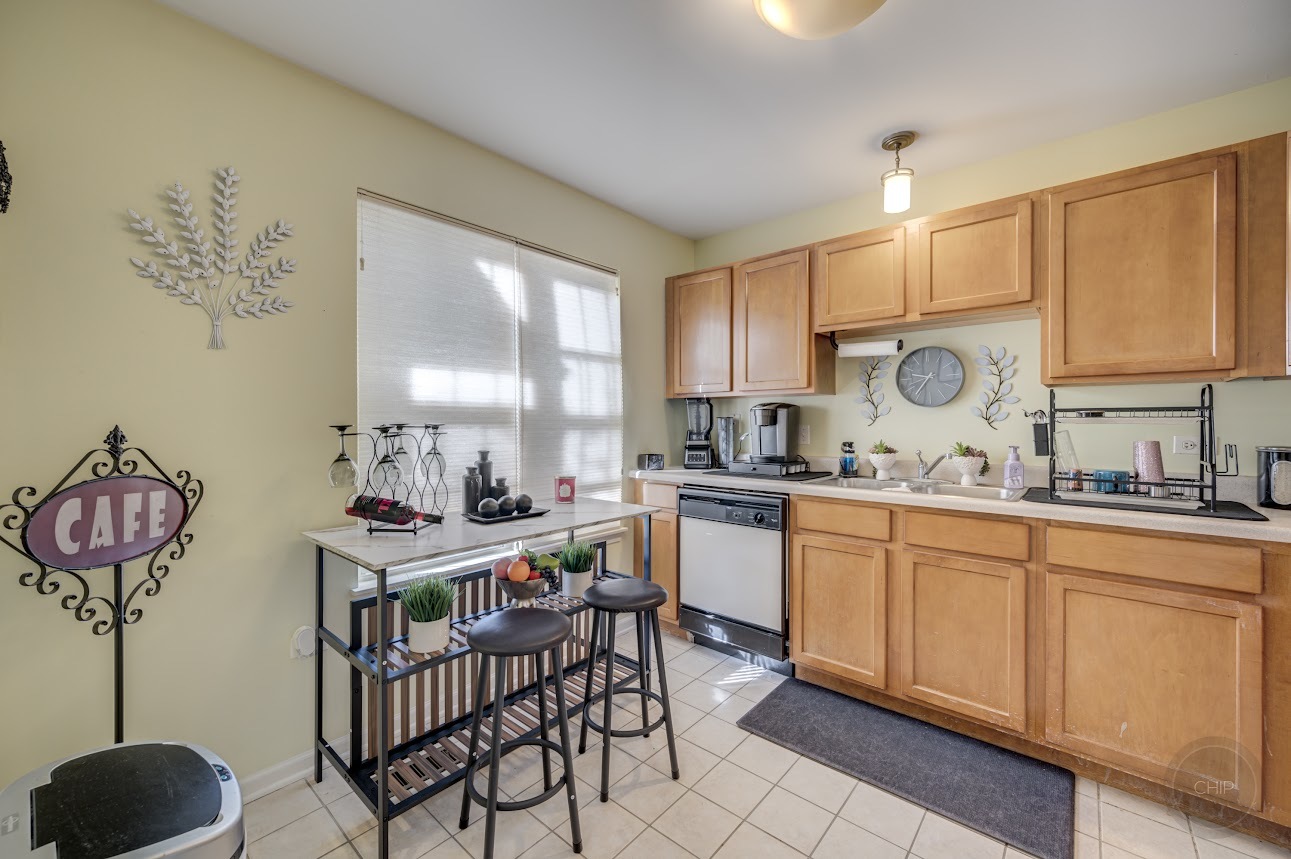 2827 Rutland Circle, Unit 101 Naperville, IL 60564 - Photo 10 of 25 a kitchen with stainless steel appliances a stove a sink and cabinets