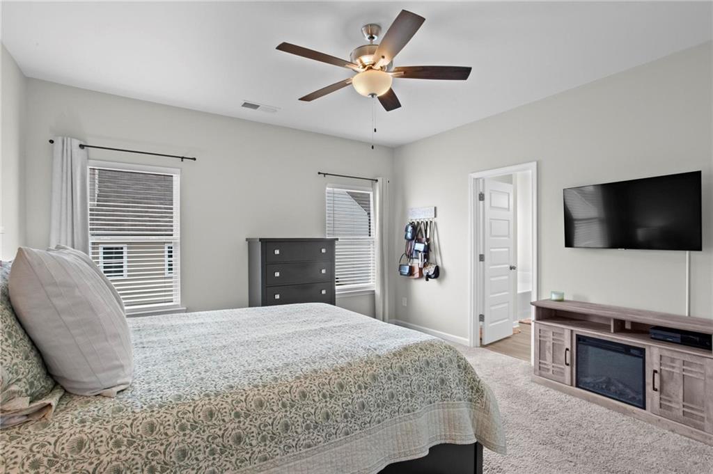 217 Eva Way Cartersville, GA 30121 - Photo 17 of 27 a bedroom with a bed and a flat screen tv