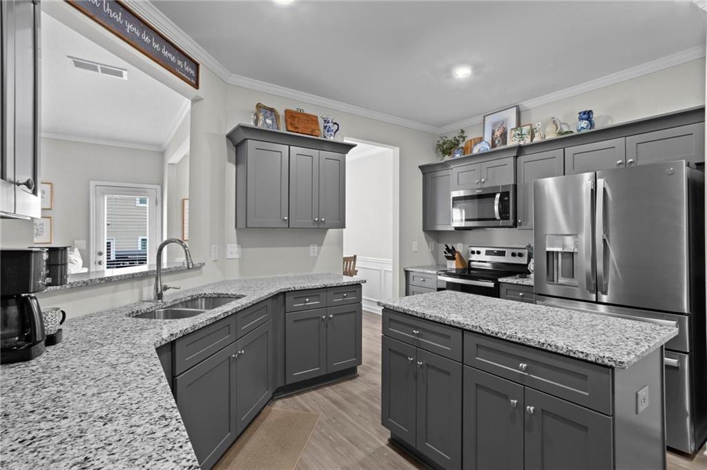 217 Eva Way Cartersville, GA 30121 - Photo 9 of 27 a kitchen with stainless steel appliances granite countertop a sink stove refrigerator and cabinets