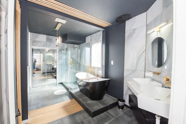 a bathroom with a sink a toilet and shower