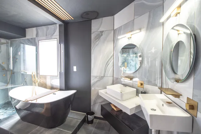 a bathroom with a bathtub a sink and a mirror