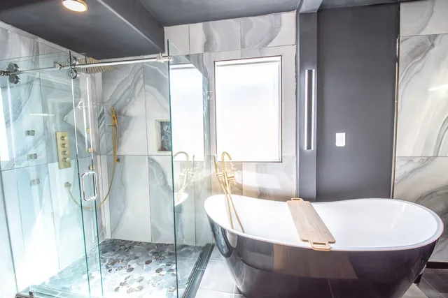 a white bath tub sitting next to a shower