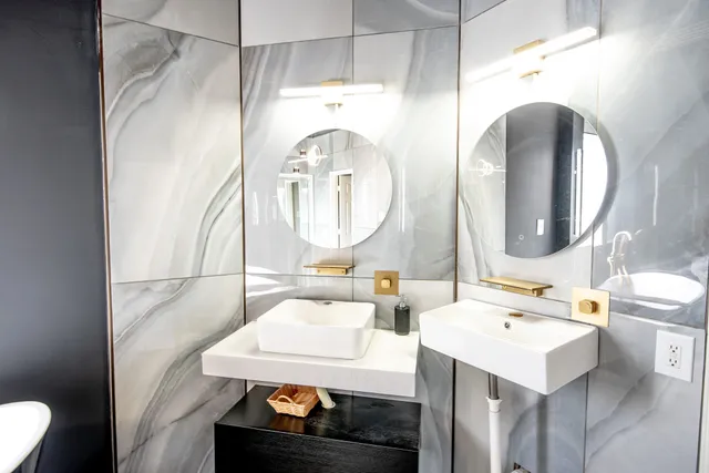a bathroom with a toilet sink and mirror