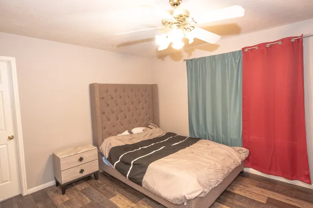 a bedroom with a bed and a chandelier