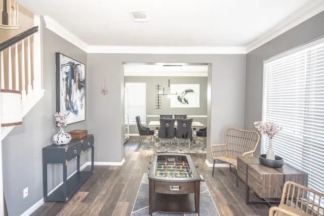 a living room with furniture and wooden floor