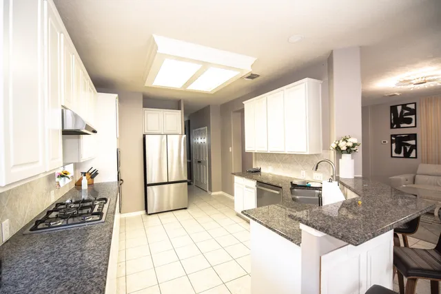 a kitchen with a stove a sink and a refrigerator