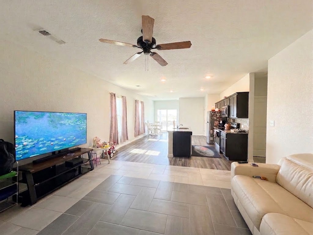 225 Comancheros Road Jarrell, TX 76537 - Photo 21 of 21 Clean tile flooring and a seamless open floorplan connect the primary living areas.