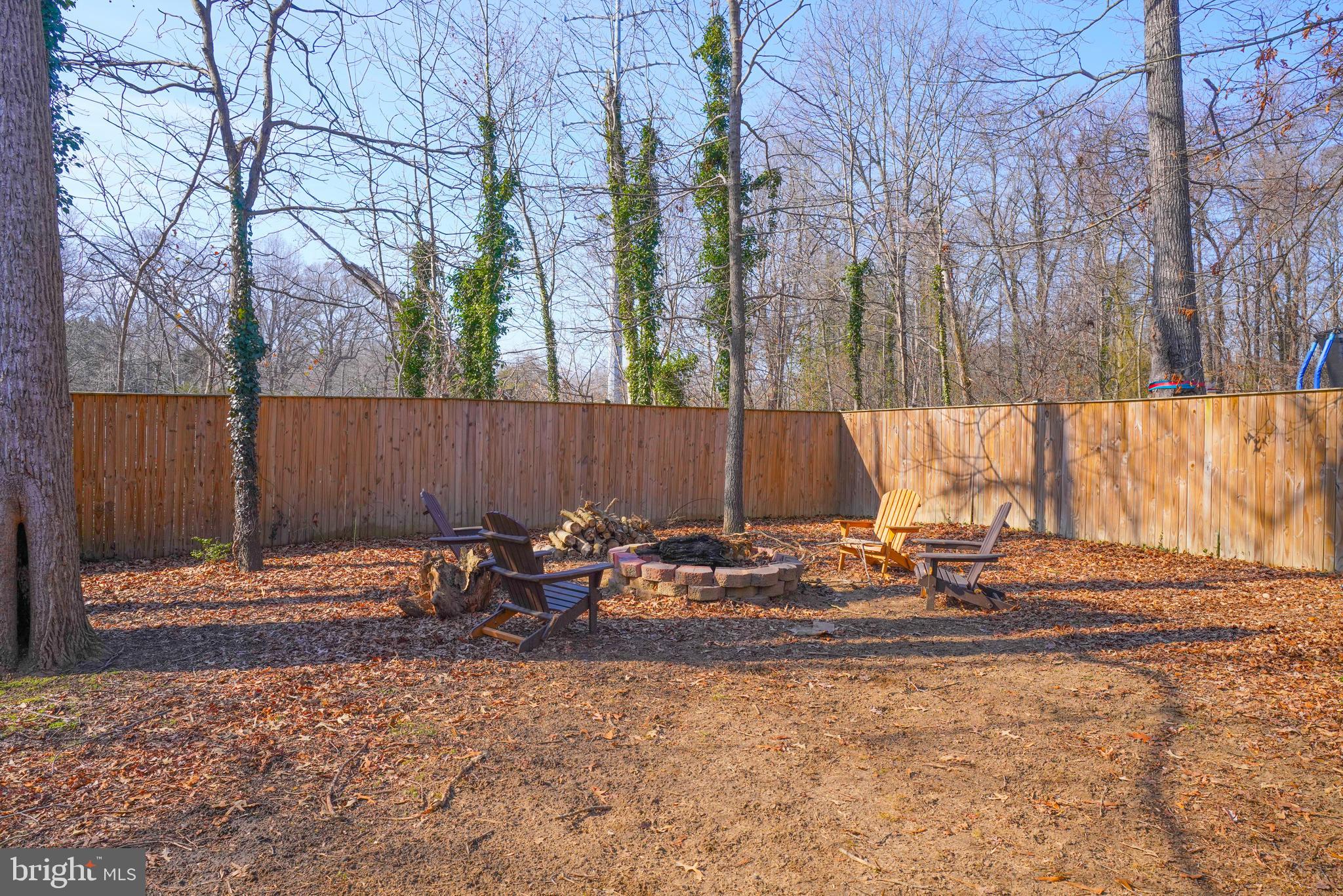 563 Maple Way Lusby, MD 20657 - Photo 15 of 16 a backyard of a house with table and chairs
