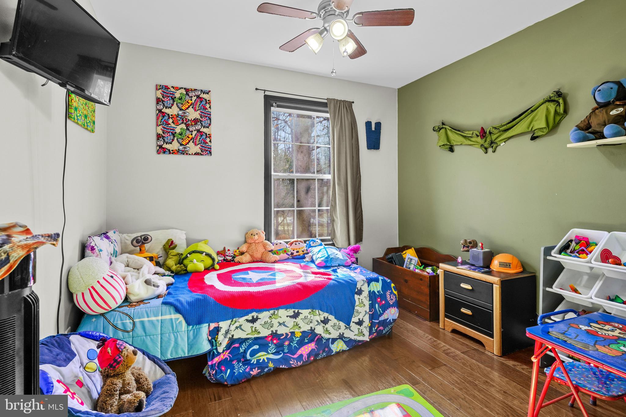 563 Maple Way Lusby, MD 20657 - Photo 6 of 16 a bedroom with a bed and a wooden floor