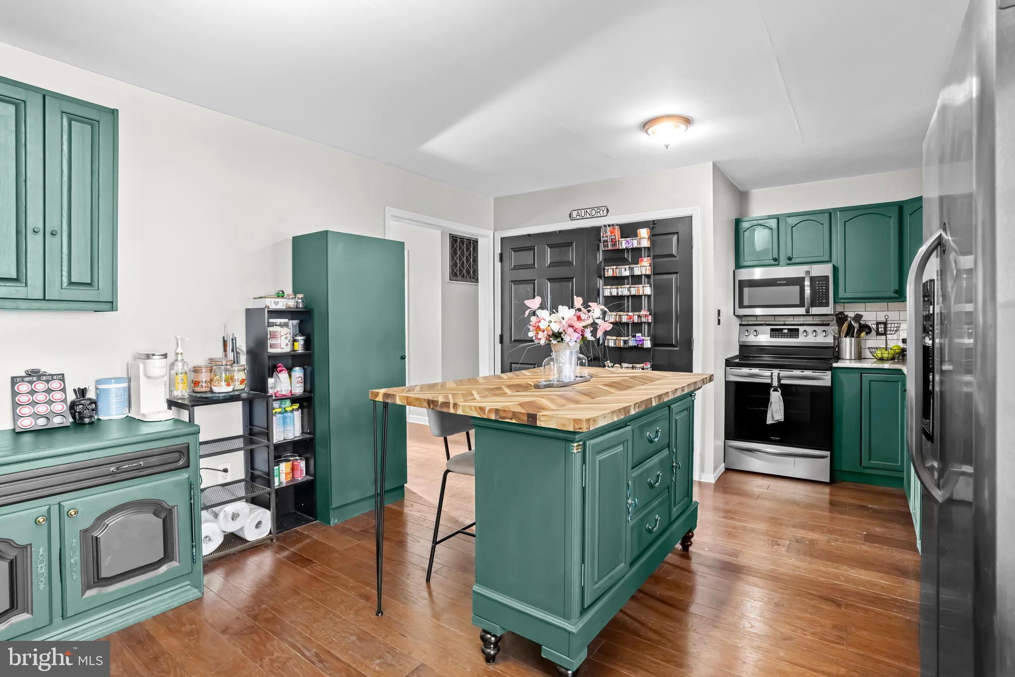 563 Maple Way Lusby, MD 20657 - Photo 10 of 16 a kitchen with stainless steel appliances granite countertop a stove refrigerator and a refrigerator