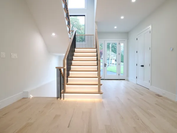 a view of entryway and hall with wooden floor