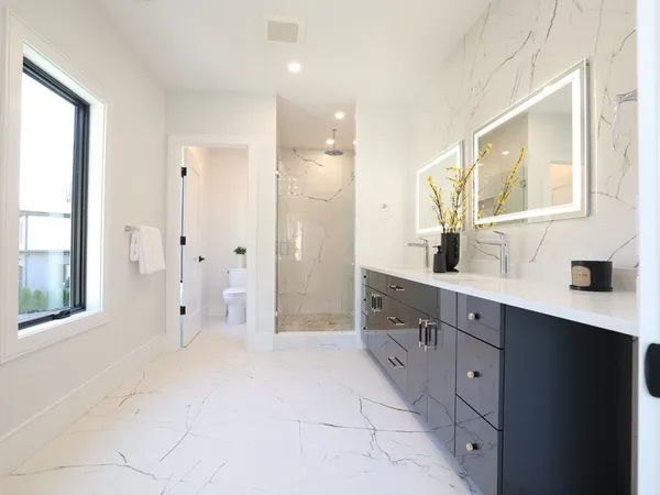 a spacious bathroom with a shower sink and mirror