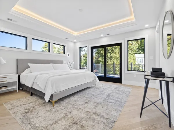 a bedroom with a bed and a large window