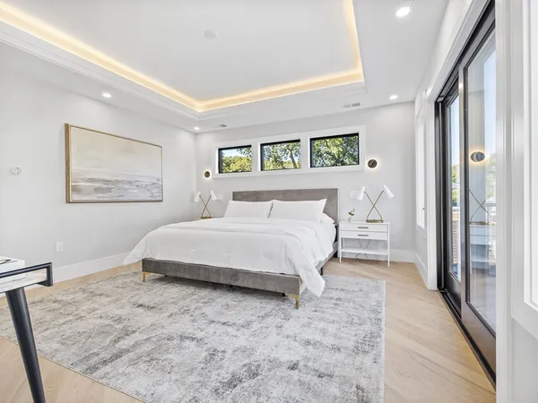 a bedroom with a bed and a painting on the wall