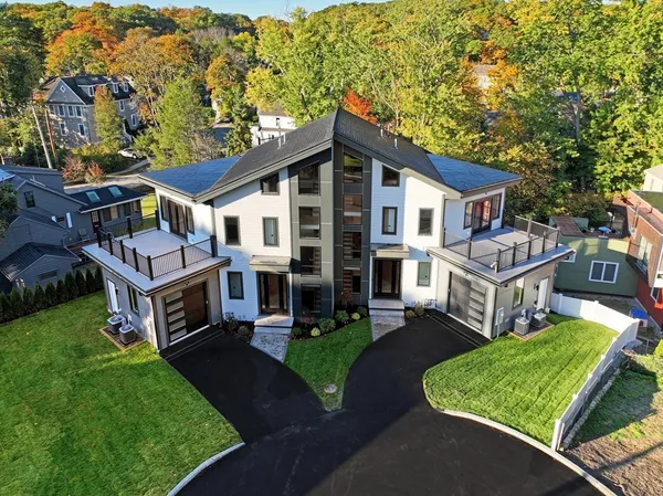 a view of a house with a yard and sitting area