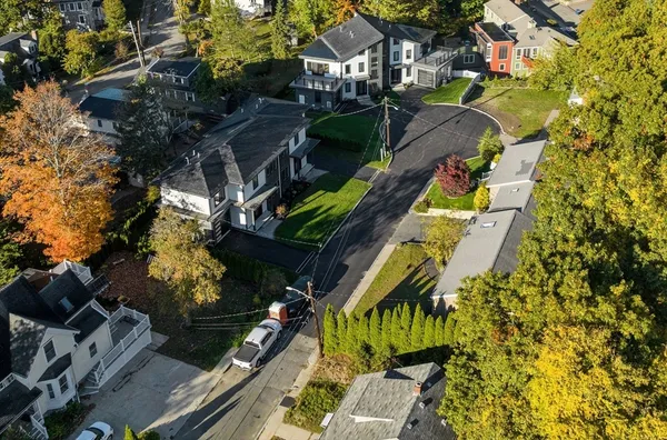 an aerial view of a house with a yard