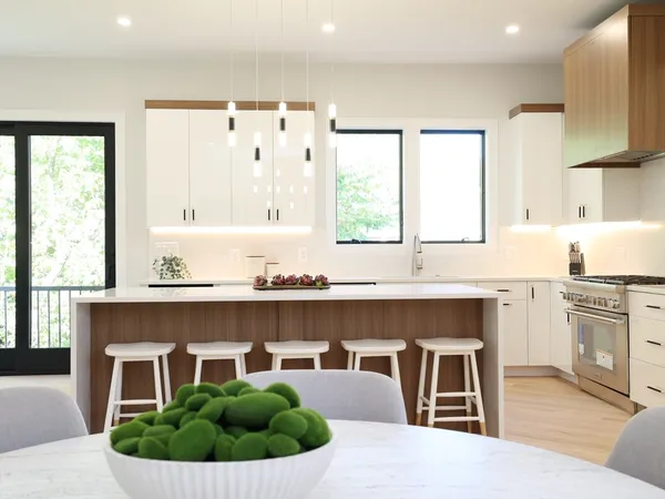 a kitchen with a table chairs sink and cabinets