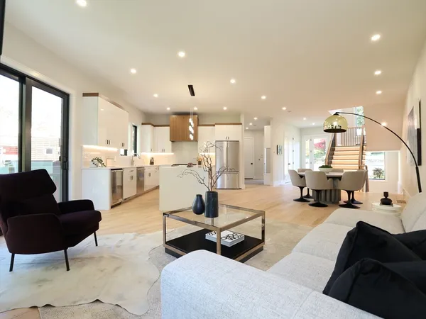 a living room with furniture and kitchen view
