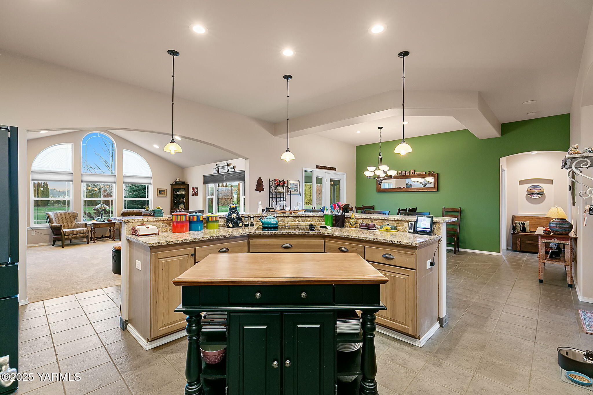 1701 Mapleway Road Yakima, WA 98908 - Photo 10 of 35 a kitchen with stainless steel appliances granite countertop a stove a sink a oven a dining table with chairs and white cabinets