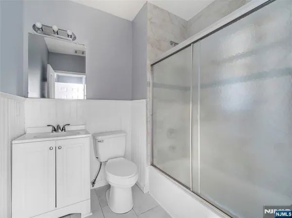 a bathroom with a toilet a sink and shower