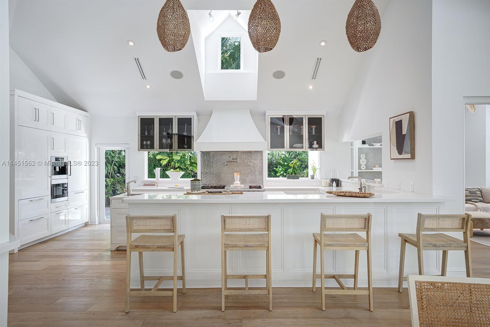 761 Buttonwood Lane Miami, FL 33137 - Photo 16 of 64 a kitchen with cabinets and chairs