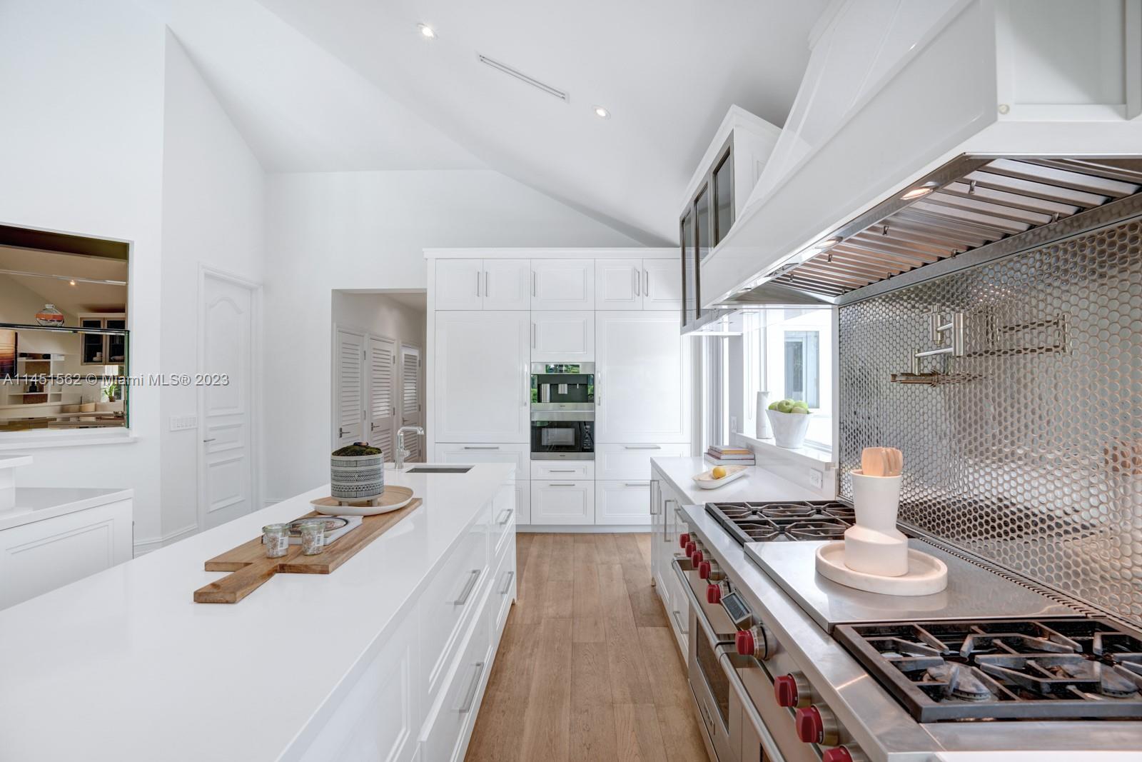 761 Buttonwood Lane Miami, FL 33137 - Photo 17 of 64 a kitchen with a stove and a sink