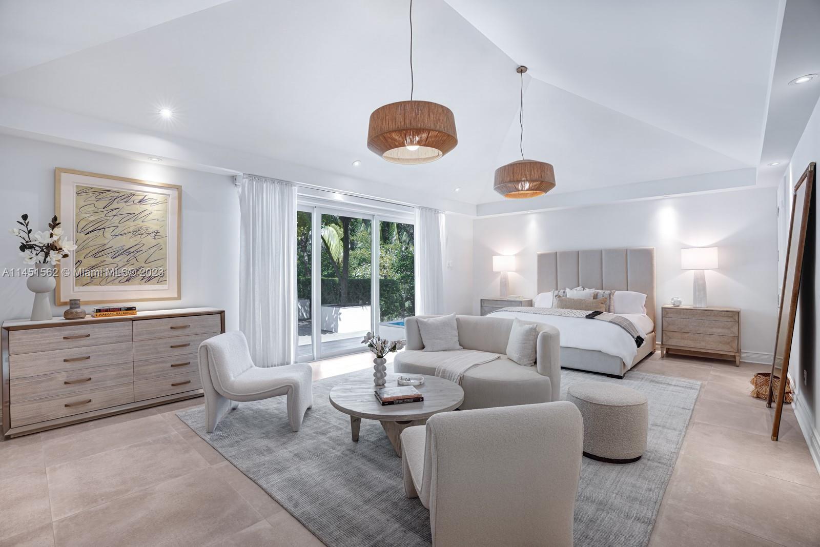 761 Buttonwood Lane Miami, FL 33137 - Photo 19 of 64 a living room with furniture a window and a chandelier