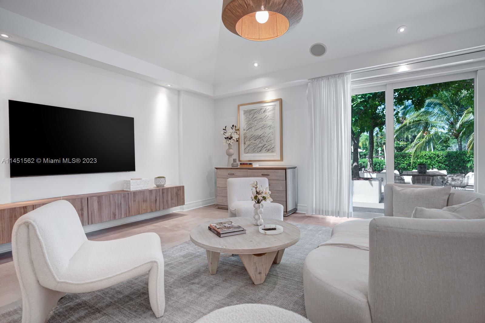 761 Buttonwood Lane Miami, FL 33137 - Photo 20 of 64 a living room with furniture and a flat screen tv
