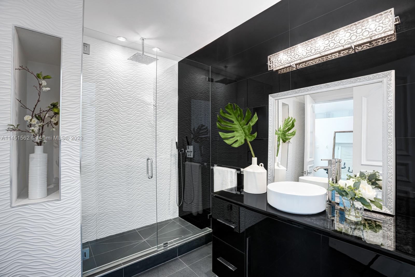 761 Buttonwood Lane Miami, FL 33137 - Photo 25 of 64 a bathroom with a sink and a mirror