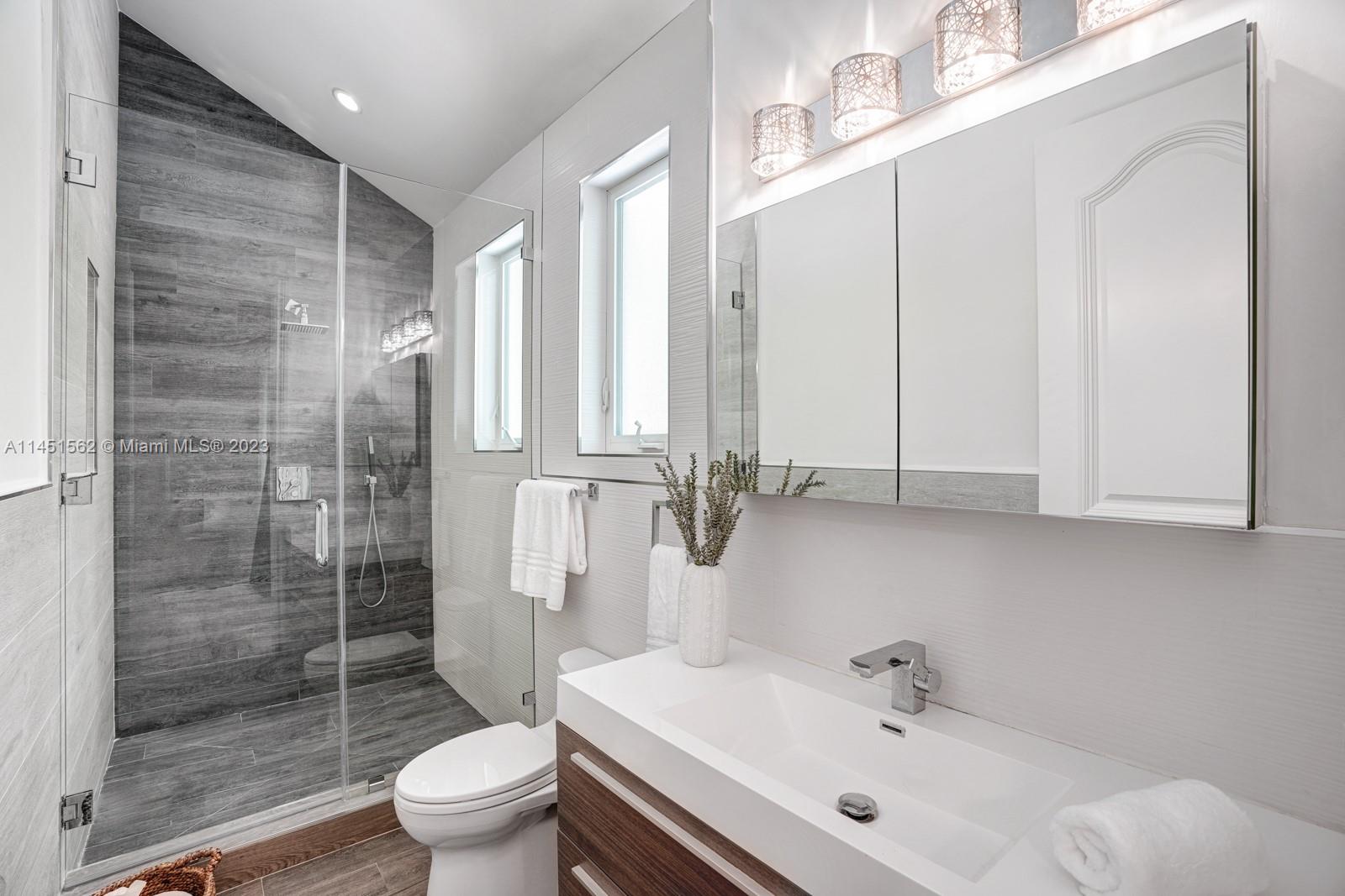 761 Buttonwood Lane Miami, FL 33137 - Photo 27 of 64 a bathroom with a sink toilet and shower