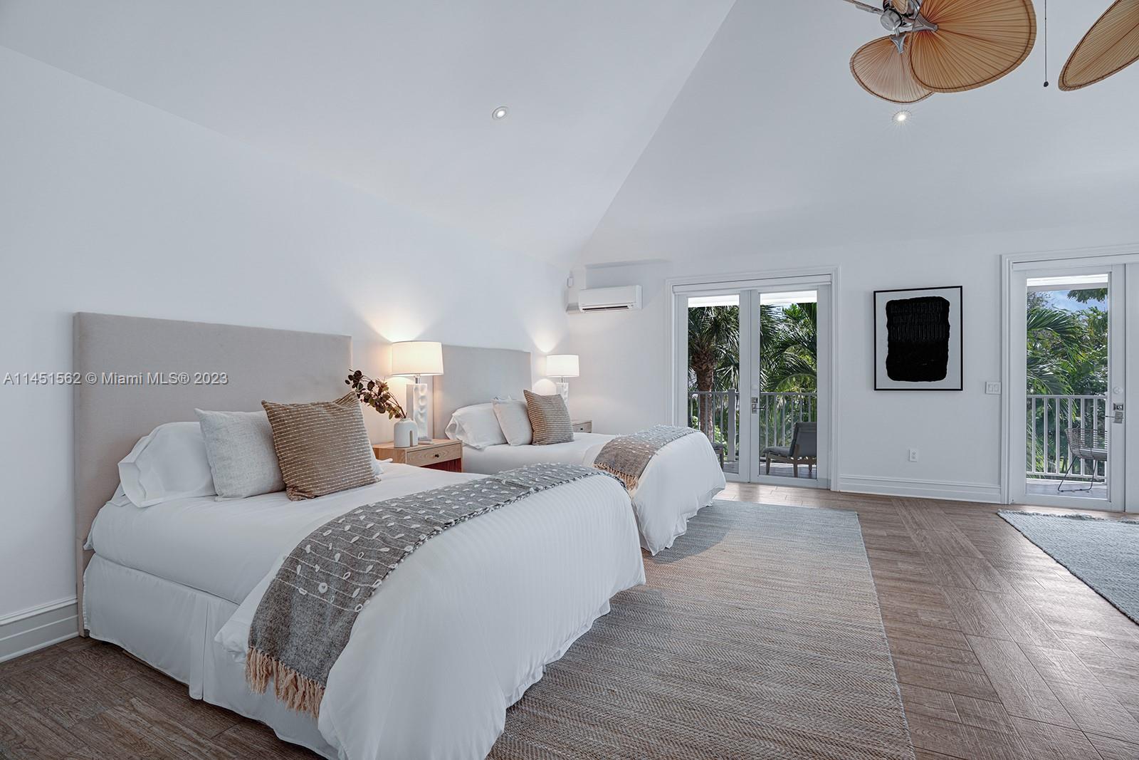 761 Buttonwood Lane Miami, FL 33137 - Photo 33 of 64 a bed room with a bed mirror and a night stand