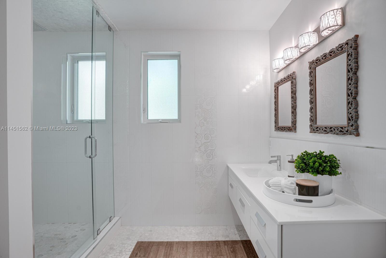 761 Buttonwood Lane Miami, FL 33137 - Photo 37 of 64 a bathroom with a tub sink and mirror