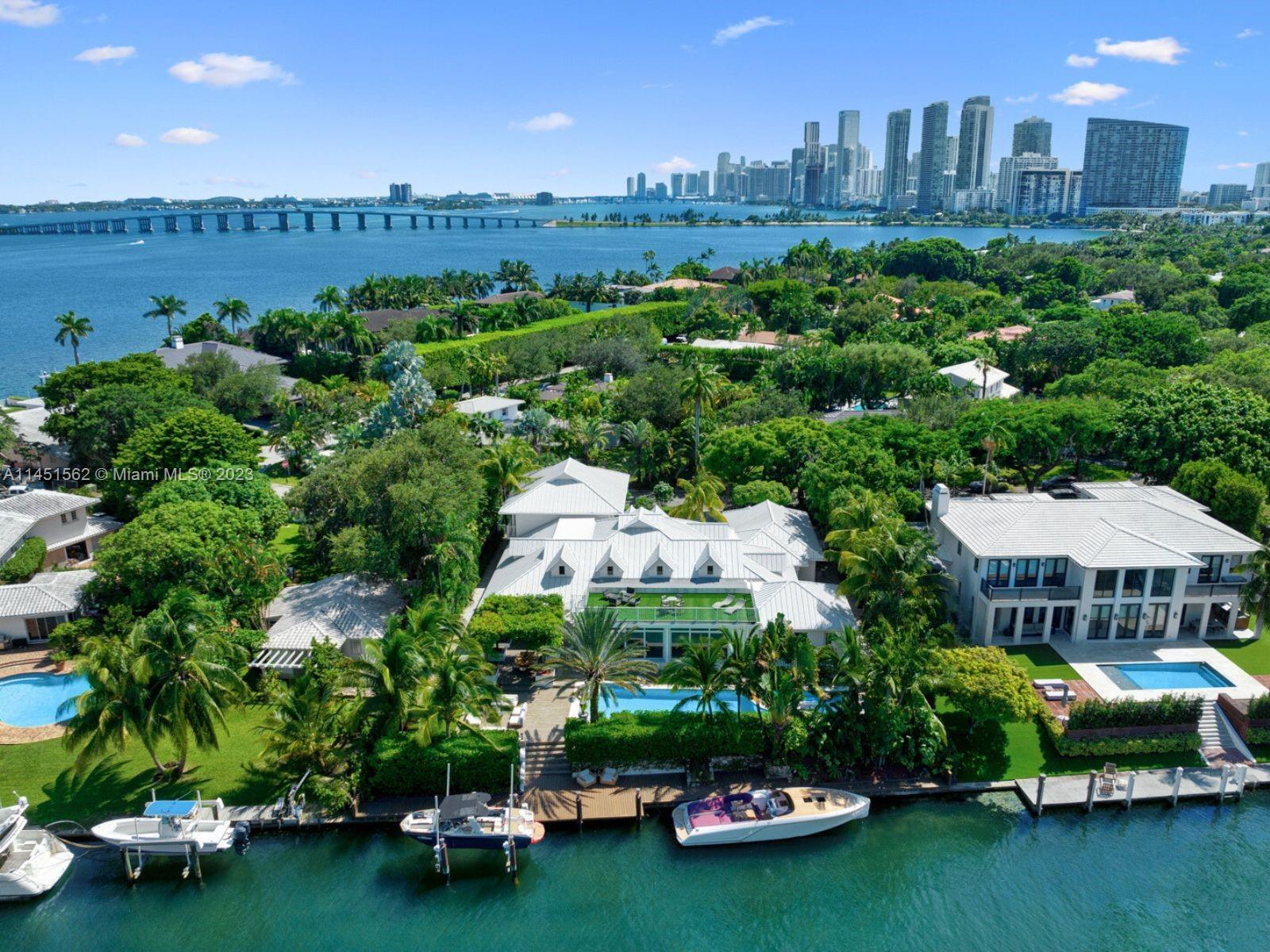 761 Buttonwood Lane Miami, FL 33137 - Photo 49 of 64 a view of a garden with lawn chairs and a large tree