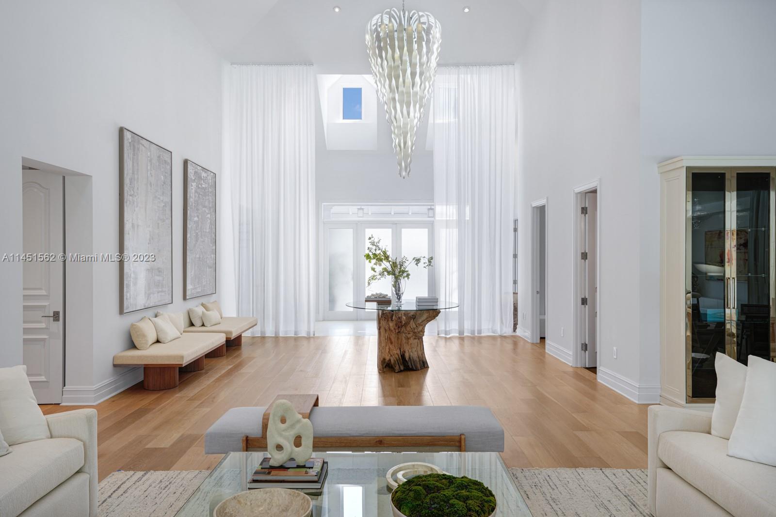 761 Buttonwood Lane Miami, FL 33137 - Photo 10 of 64 a living room with furniture and a chandelier