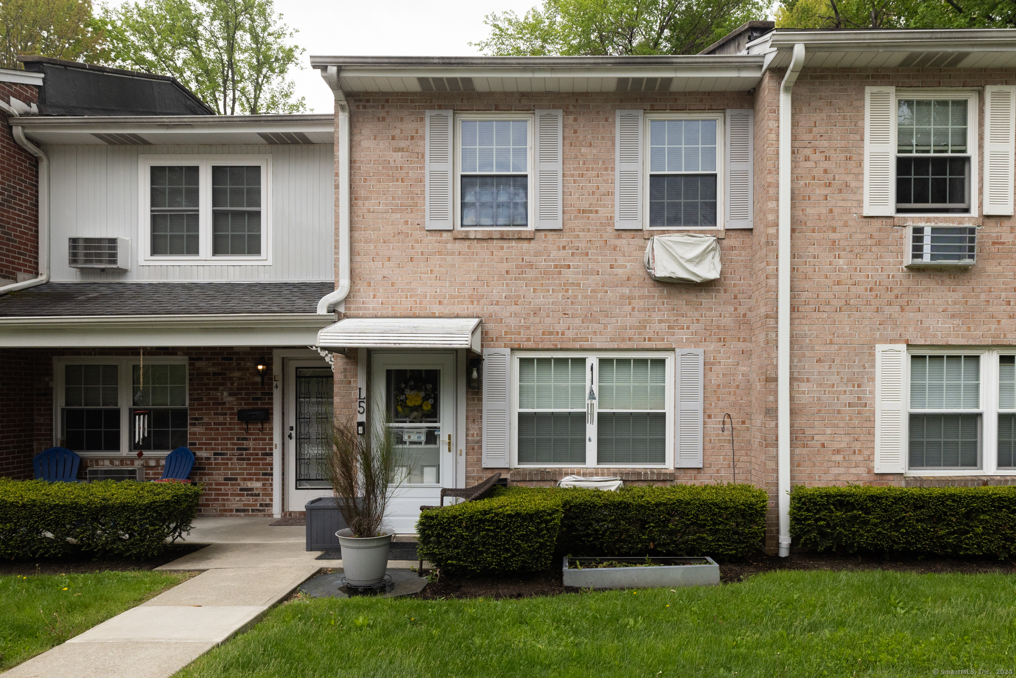 5 Surrey Lane, Unit L5 Torrington, CT 06790 - Photo 1 of 1 a front view of a house with a yard