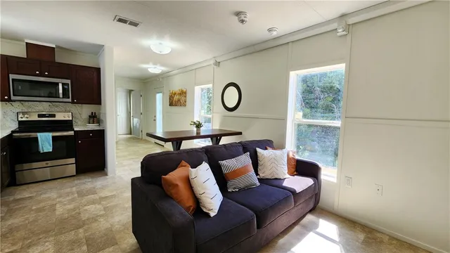 a living room with furniture and a large window