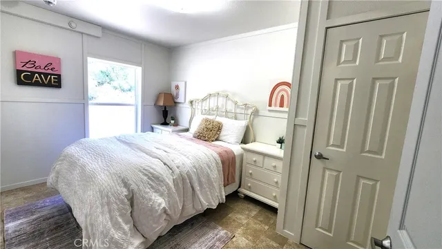 a view of house with yard and trees in the background