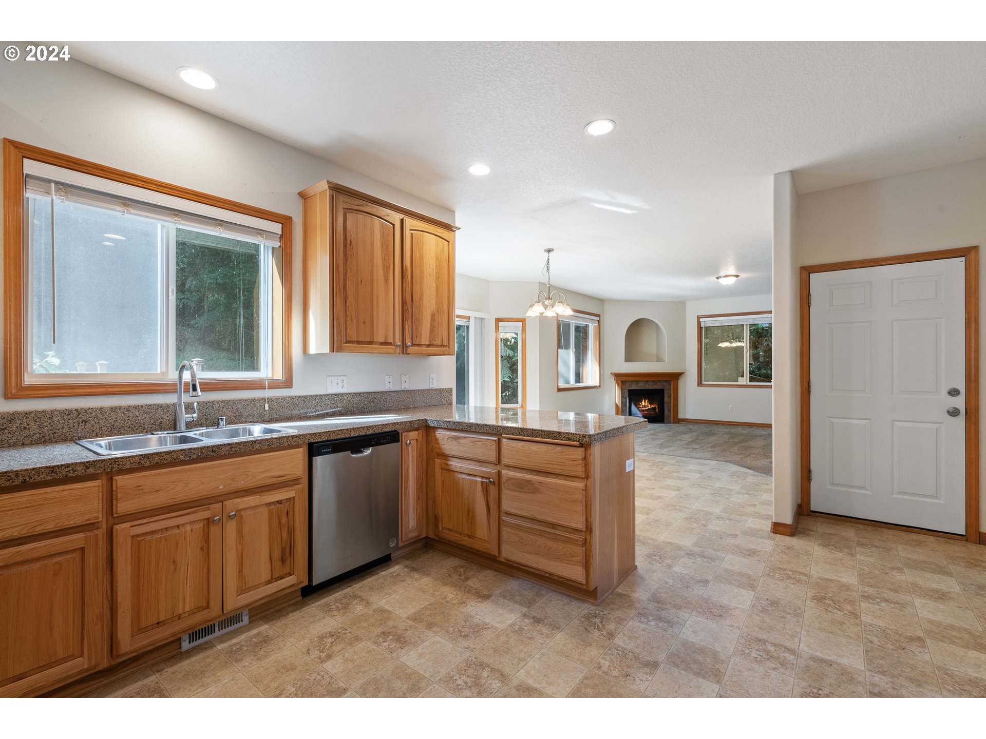 8009 Northeast 16th Street Vancouver, WA 98664 - Photo 11 of 46 a large white kitchen with stainless steel appliances granite countertop a sink and dishwasher with a large window