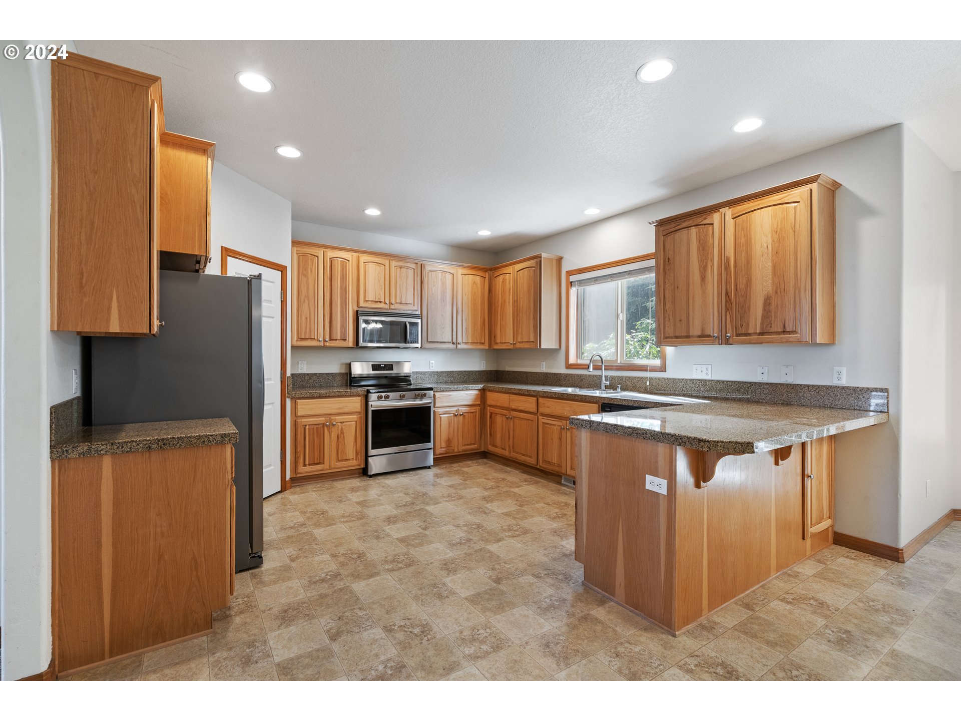 8009 Northeast 16th Street Vancouver, WA 98664 - Photo 12 of 46 a kitchen with stainless steel appliances granite countertop a stove a sink dishwasher a refrigerator and a oven