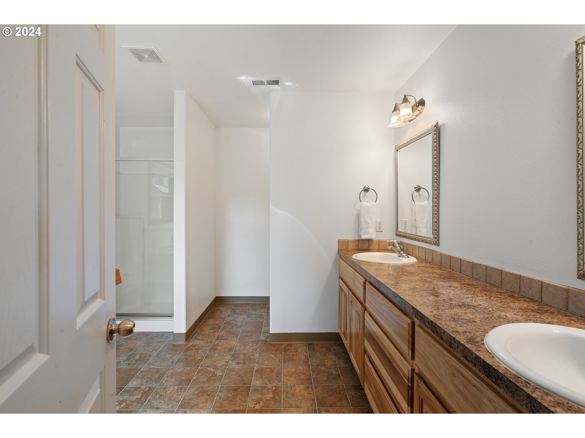 8009 Northeast 16th Street Vancouver, WA 98664 - Photo 30 of 46 a bathroom with a granite countertop sink and a mirror