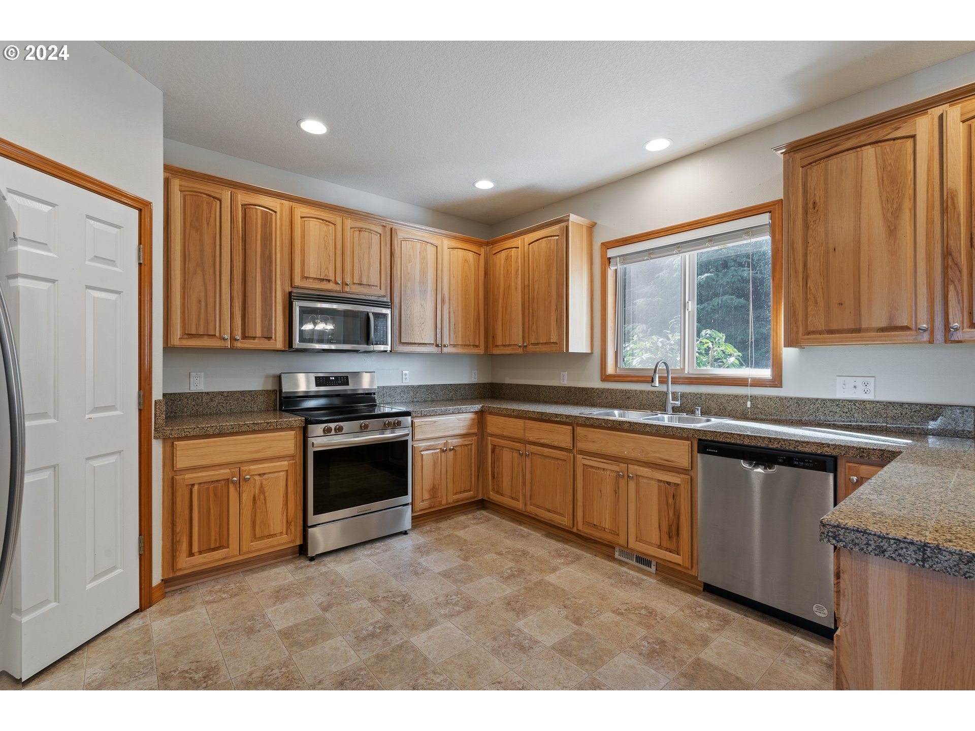 8009 Northeast 16th Street Vancouver, WA 98664 - Photo 7 of 46 a kitchen with stainless steel appliances granite countertop a stove sink and cabinets