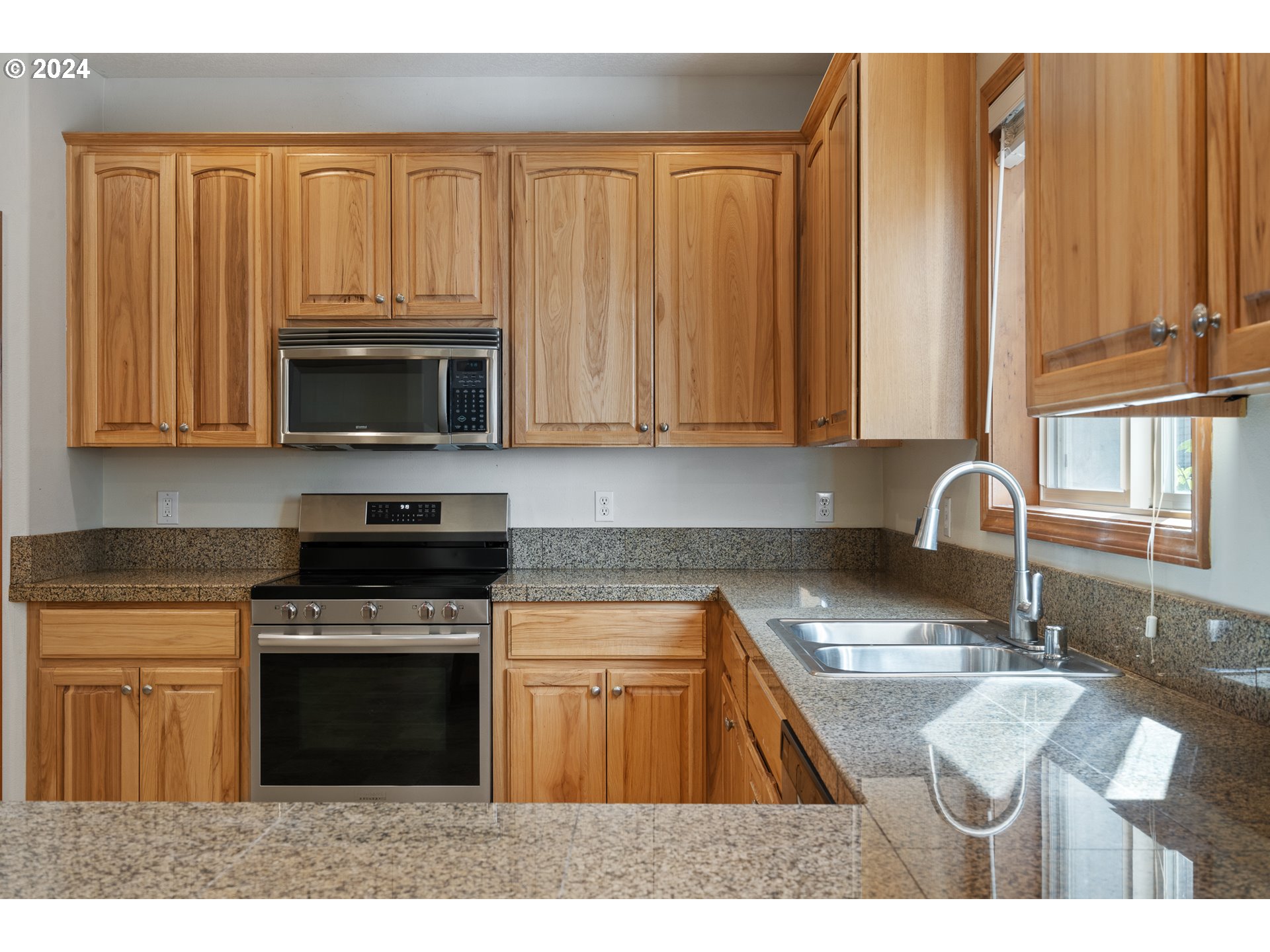 8009 Northeast 16th Street Vancouver, WA 98664 - Photo 8 of 46 a kitchen with a stove a sink and a microwave