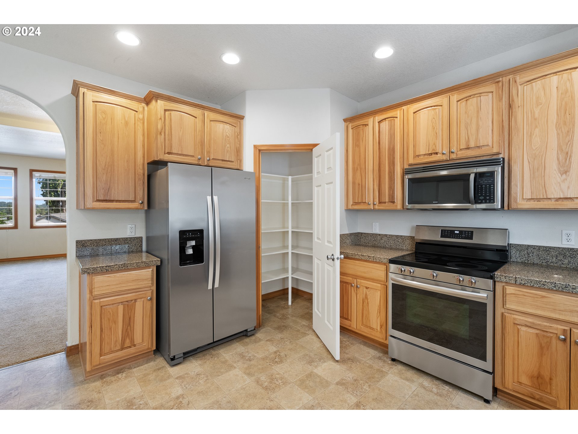 8009 Northeast 16th Street Vancouver, WA 98664 - Photo 9 of 46 a kitchen with granite countertop a refrigerator stove and microwave