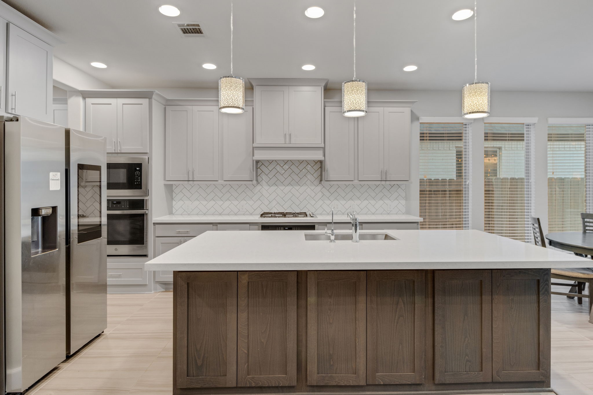17467 Bayflower Conroe, TX 77385 - Photo 12 of 44 a large kitchen with a large counter top stainless steel appliances and cabinets