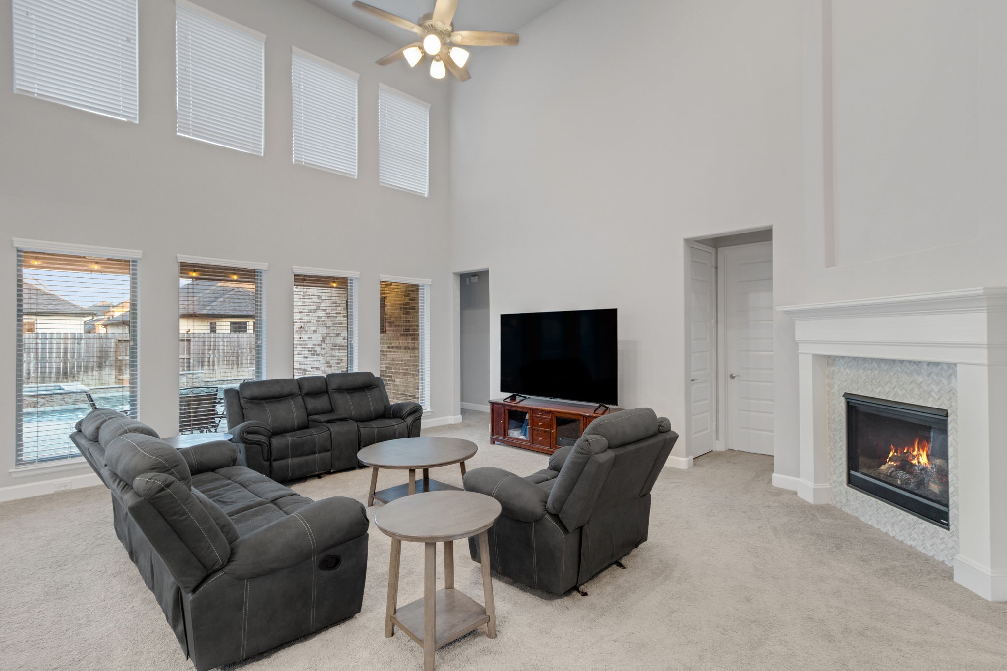 17467 Bayflower Conroe, TX 77385 - Photo 17 of 44 a living room with furniture a fireplace and a flat screen tv