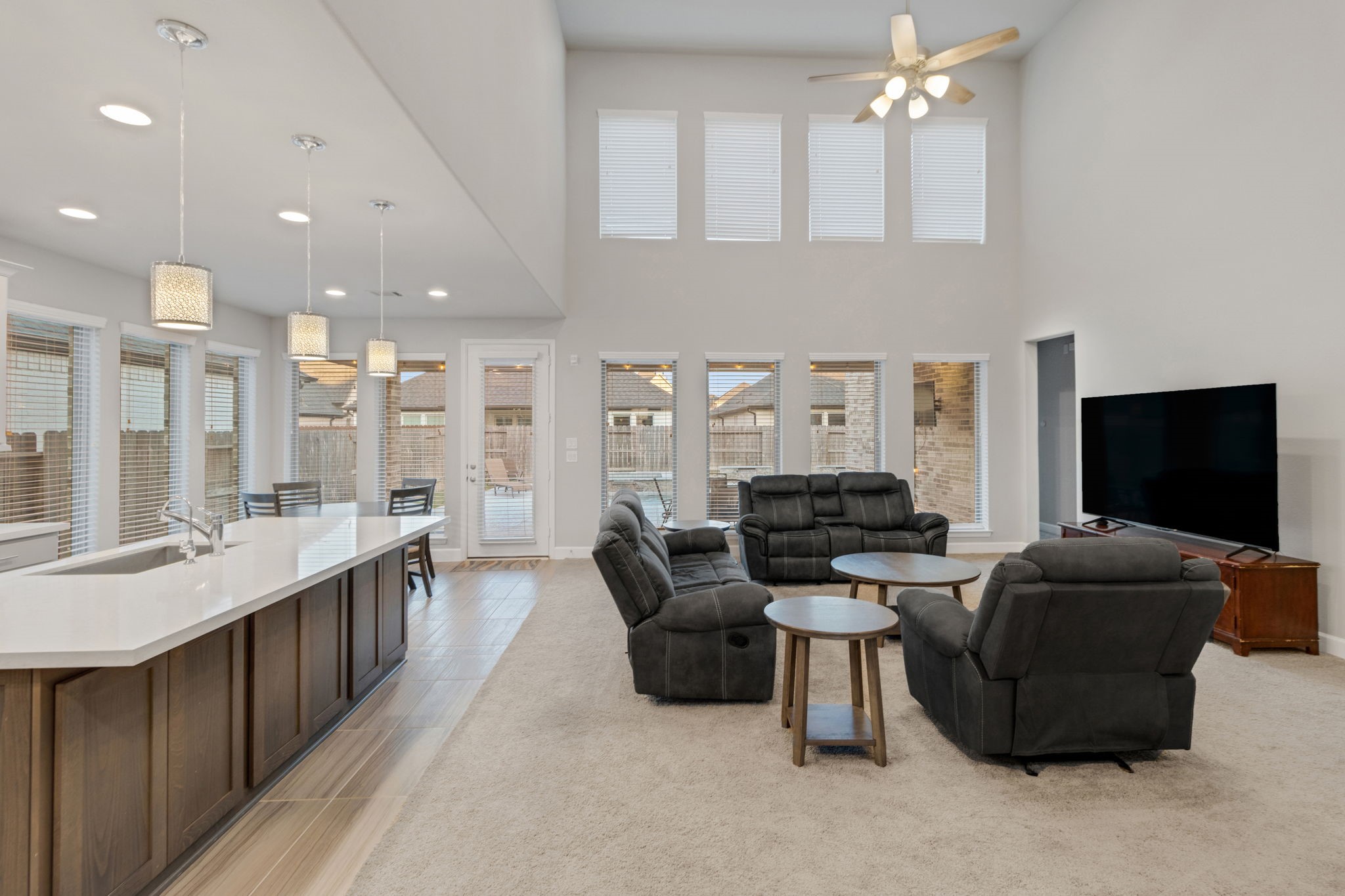 17467 Bayflower Conroe, TX 77385 - Photo 20 of 44 a living room with furniture a flat screen tv and kitchen view